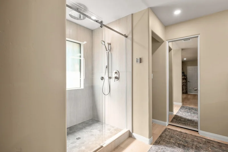 Reconfigured bathroom with glass-enclosed shower